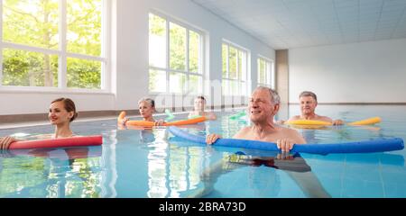 Women and men in water exercises during remobilization class Stock Photo
