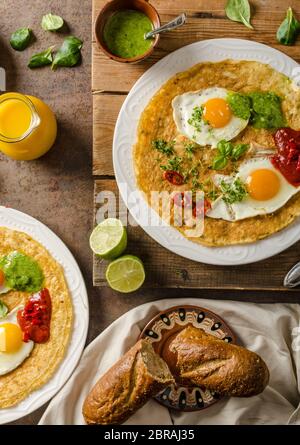 Huevos divorciados, delicious food with eggs, fresh salad and herbs and spicy and herby sauce Stock Photo