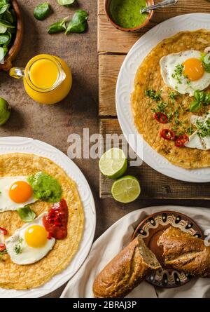 Huevos divorciados, delicious food with eggs, fresh salad and herbs and spicy and herby sauce Stock Photo