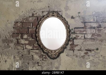Vintage antique mirror on old brick wall background texture, space for text Stock Photo