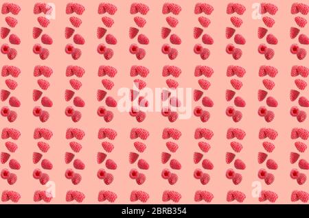 Fruit pattern. Colorful of fresh raspberries texture slices on coral pastel background. From top view. Stock Photo