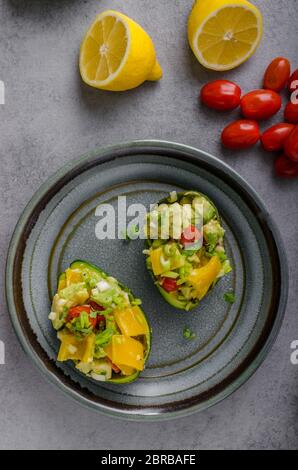 Stuffed avocado with vegetable, bio healthy recipe Stock Photo