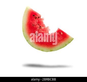 bitten off a piece of ripe red round watermelon with seeds on a white background Stock Photo