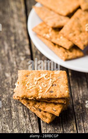 Salted crispy crackers on wooden table. Stock Photo