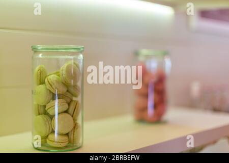Colorful French or Italian macaron stack on white counter Stock Photo