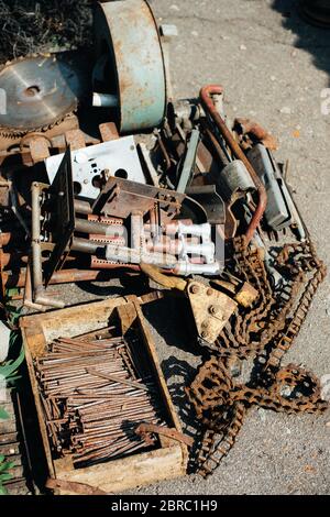 Pile of scrap metal. Rye green pipes. various iron products are in wooden crates. Corrosion on an old satellite dish. Close-up. Macro. Corrosion of me Stock Photo