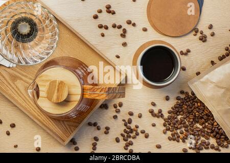 Directly above shot of fresh coffee with roasted beans on wooden table Stock Photo