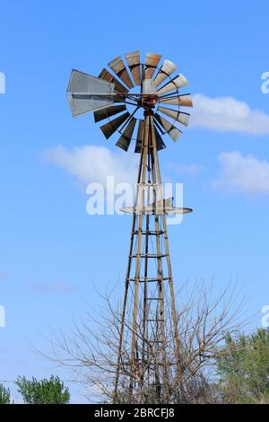 Kansas colorful Spring day with a Windmill in a pasture with tree's ...