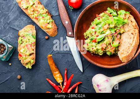 Traditional mexican sauce guacamole and bruschetta.Mexican food Stock Photo