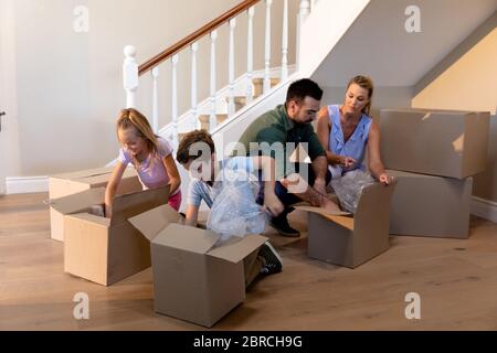 Caucasian couple and their children arriving at their new home Stock Photo
