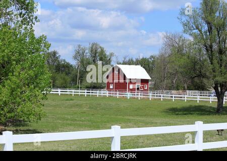 Kansas Red and white barn out in the country with blue sky and white ...