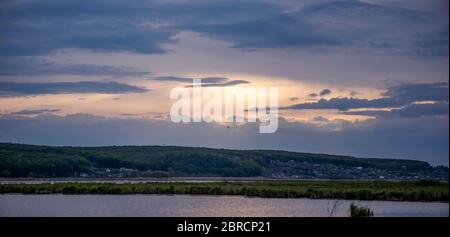 Evening landscape with lake, reeds and dramatic sky Stock Photo