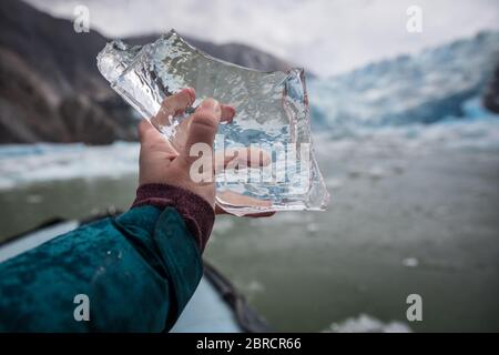 icebergs calved from South Sawyer Glacier float down Tracy Arm Fjord, Southeast Alaska, USA, past adventurous tourists on skiff boats from a cruise Stock Photo