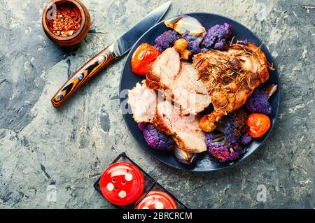 Italian pork porchetta with cauliflower.Traditional italian holiday food. Stock Photo