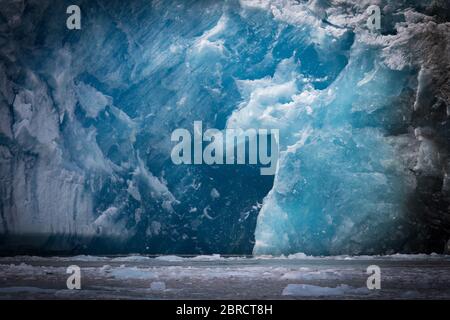 Sawyer Glacier, Tracy Arm Fjord, Southeast Alaska, is an active tidewater glacier appreciated by tourists on small ship cruises and boat tours. Stock Photo