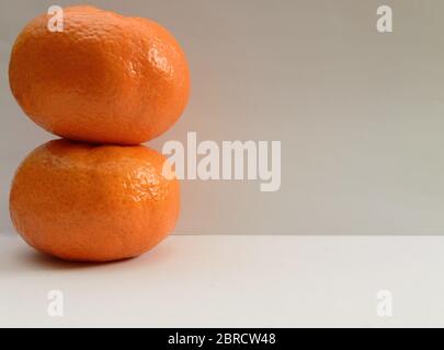 Two Tangerines On Top Of Each Other On White Background Stock Photo