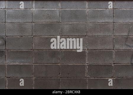Masonry wall made of gray rectangular stone Stock Photo