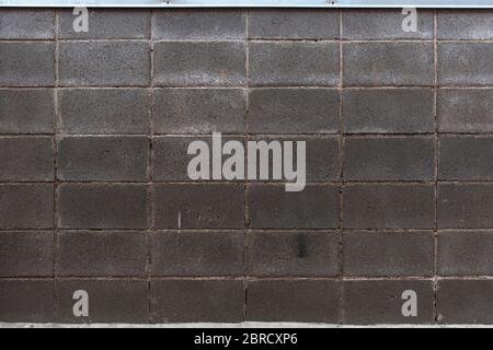 Masonry wall made of gray rectangular stone Stock Photo