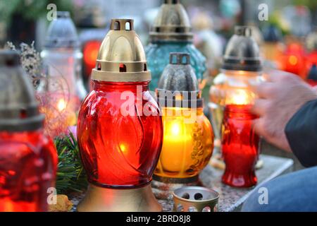 Lighting candles on the grave. All the Saints Day holiday on 1 November in Poland Stock Photo
