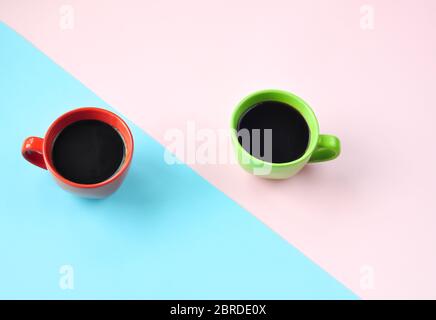 Americano in the different cups on the pink background. Flat Lay, cheerful day concept. This image could be used to show coffee break time or morning Stock Photo