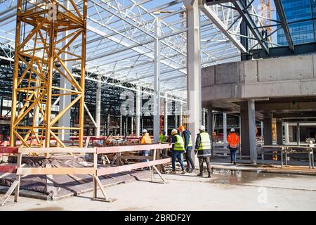 Group of engineers standing on construction site, talking. Stock Photo