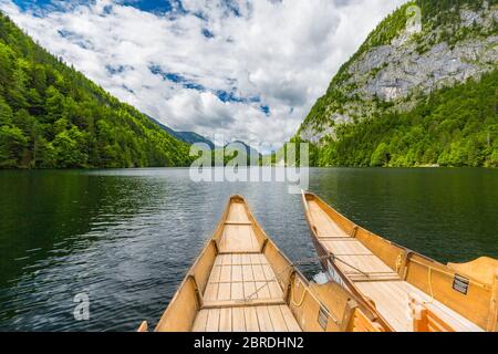 A dramatic sunset from an old canoe on a clam mountain lake in the Stock Photo