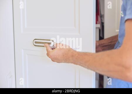 Installation of new cabinet, handyman sets door handles Stock Photo