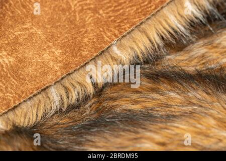 Close-up of a fluffy dark brown faux fur fabric with a background texture. Brown artificial fabric, can be used as a background. Fur for toys or cloth Stock Photo