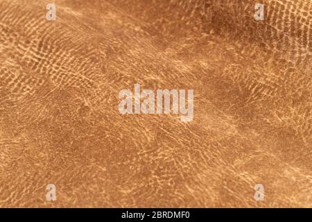 brown faux suede leather for the concept and style idea of fine leather craft, handmade work space. Background textures and Wallpapers. Stock Photo