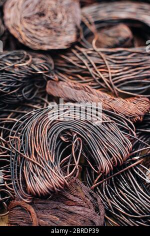 Copper scrap metal, wire, windings of motors and transformers, electrical wire without insulation. Calcined oxidized copper wire. Against the backgrou Stock Photo