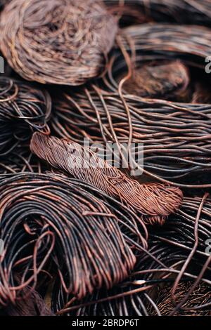 Copper scrap metal, wire, windings of motors and transformers, electrical wire without insulation. Calcined oxidized copper wire. Against the backgrou Stock Photo