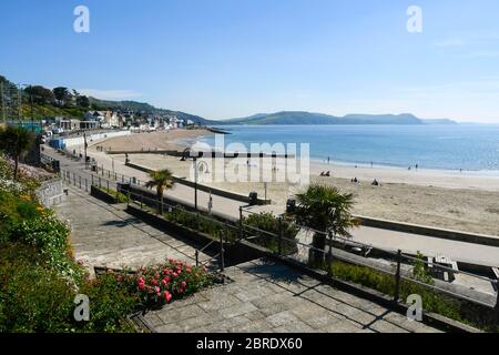 Lyme Regis, Dorset, UK.  21st May 2020.  UK Weather.  Families on the beach early sunbathing at the seaside resort of Lyme Regis in Dorset on a scorching hot sunny morning.  Picture Credit: Graham Hunt/Alamy Live News Stock Photo