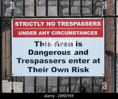 No Trespassers sign on old metal railings, United Kingdom Stock Photo