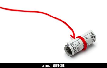 Money trap, cheating. Cash dollars tied with red rope. Isolated on white background. Stock Photo