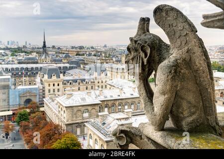 Chimera (gargoyle) of the Cathedral of Notre Dame de Paris overlooking Paris, France Stock Photo