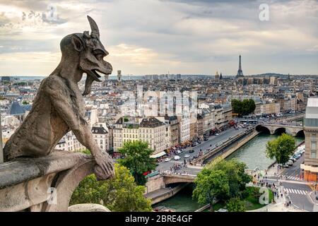 Chimera (gargoyle) of the Cathedral of Notre Dame de Paris overlooking Paris, France Stock Photo