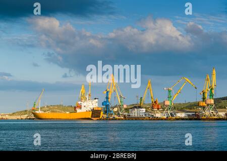 Harbor with cranes in Feodosia, Crimea Stock Photo