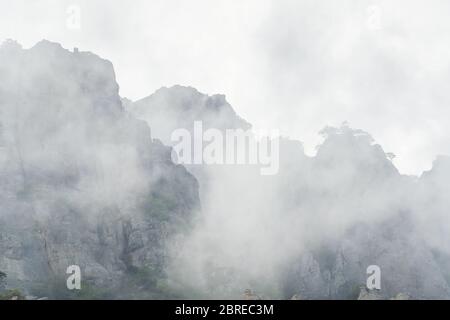 The Demerdji mountain with low lying clouds. Valley of ghosts. Landscape of Crimea, Russia. Stock Photo