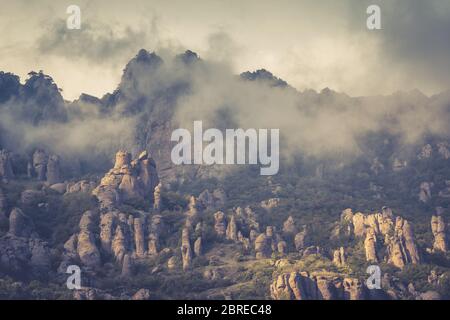 The Demerdji mountain with low lying clouds, Crimea, Russia. Valley of Ghosts. Stock Photo