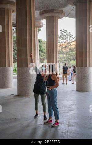 Mom and daughter enjoying architecture of Park Güell in Barcelona, Spain on 20th of May 2020. The park reopens its doors today after more than two and a half months closed to the public. Due to border closure neighbors can enjoy the emblematic area without mass tourism overcrowding it. The city continues to remain at stage zero of gradual decompression of confinement restrictions. Even so, security measures are updated day after day. Spain faces the 67th day of state of emergency due to the Coronavirus pandemic. (Photo by Carmen Molina/Sipa USA) Stock Photo