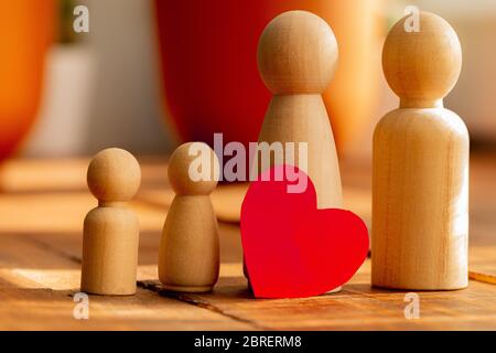 Small wooden figures of family members. Family relationship symbol Stock Photo