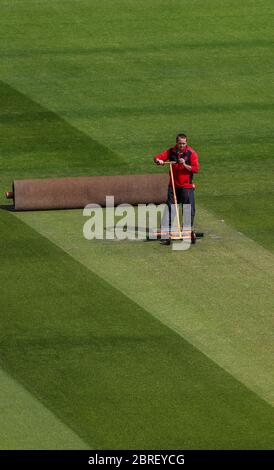 Groundsman David Shortt works on the pitch at Emirates Old Trafford, home of Lancashire CCC. Stock Photo