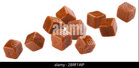 Falling toffee candy, flying caramel candies isolated on white background Stock Photo