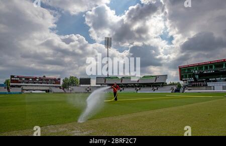 Groundsman David Shortt works on the pitch at Emirates Old Trafford, home of Lancashire CCC. Stock Photo