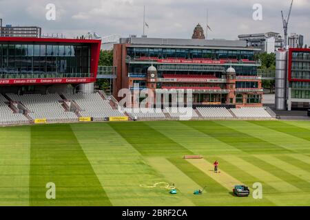 Groundsman David Shortt works on the pitch at Emirates Old Trafford, home of Lancashire CCC. Stock Photo