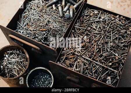 Scrap metal. Box with old rusty nails. Close-up. Macro. Stock Photo
