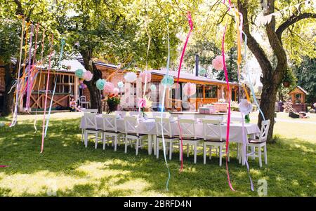 A table set for kids birthday party outdoors in garden in summer. Stock Photo
