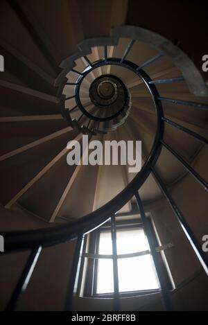 Looking up a stone spiral staircase in old traditional London building