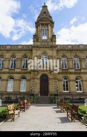 Saltaire Victoria Hall with white clouds and blue sky in the background,Victoria Road, Shipley, West Yorkshire, England, UK.. Stock Photo