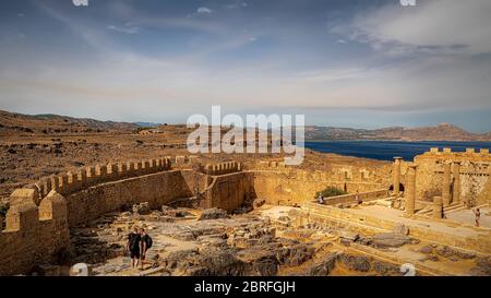 LINDOS, GREECE - OCTOBER 04, 2018: Some tourists at the Lindos acropolis on the Greek island of Rhodes. Stock Photo